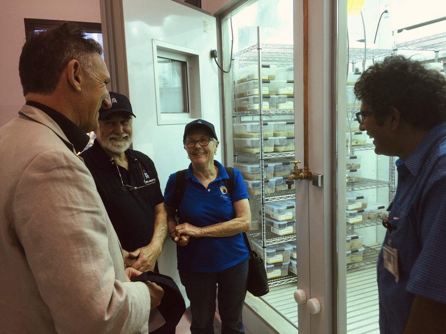 Geoff Gurr (far left) and Agasthya Thotagamuwa (far right) showing Bernard and Loene Doube (centre) the Moroccan O. vacca that will soon be released using their Farmer Nurseries