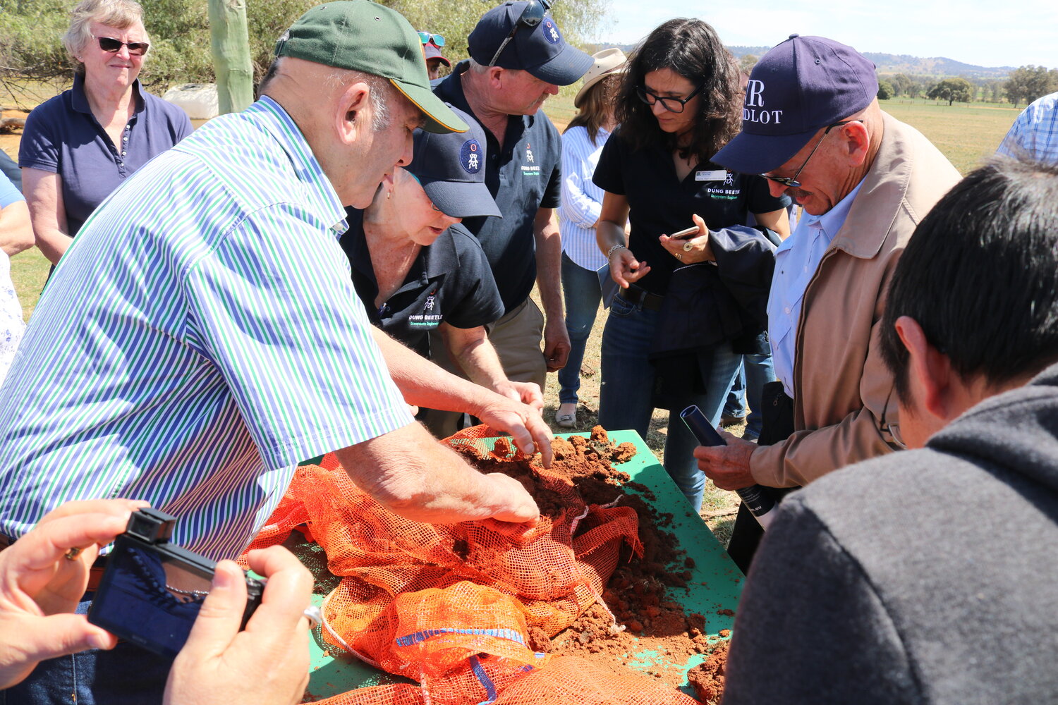 Chips Boucher, John Richards and Loene Doube examine a soil core for buried beetle brood balls