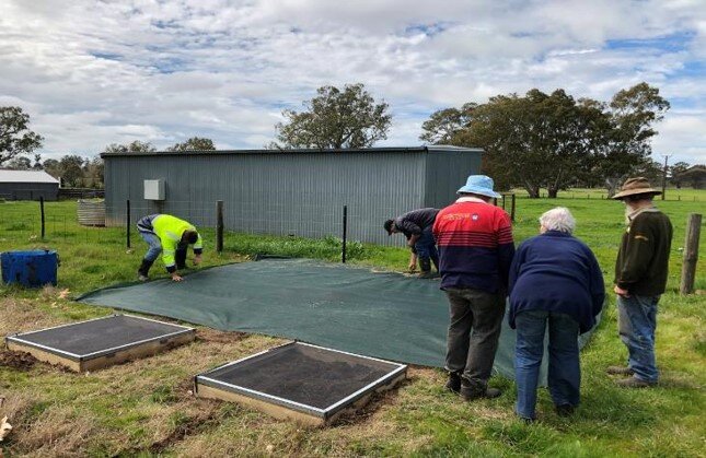 A typical pilot DBEE release site with 2 cages and a covered ‘arena’. The soil cores are under the area.